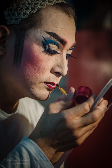 Chinese opera performer putting on make up